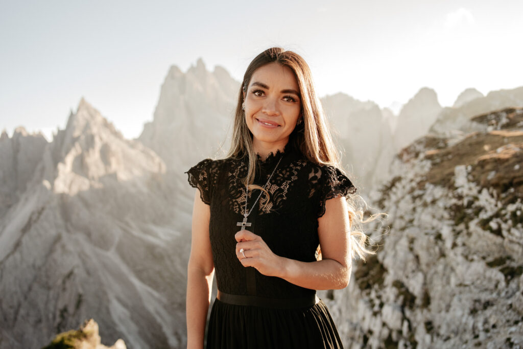 Woman in black dress, mountain landscape background