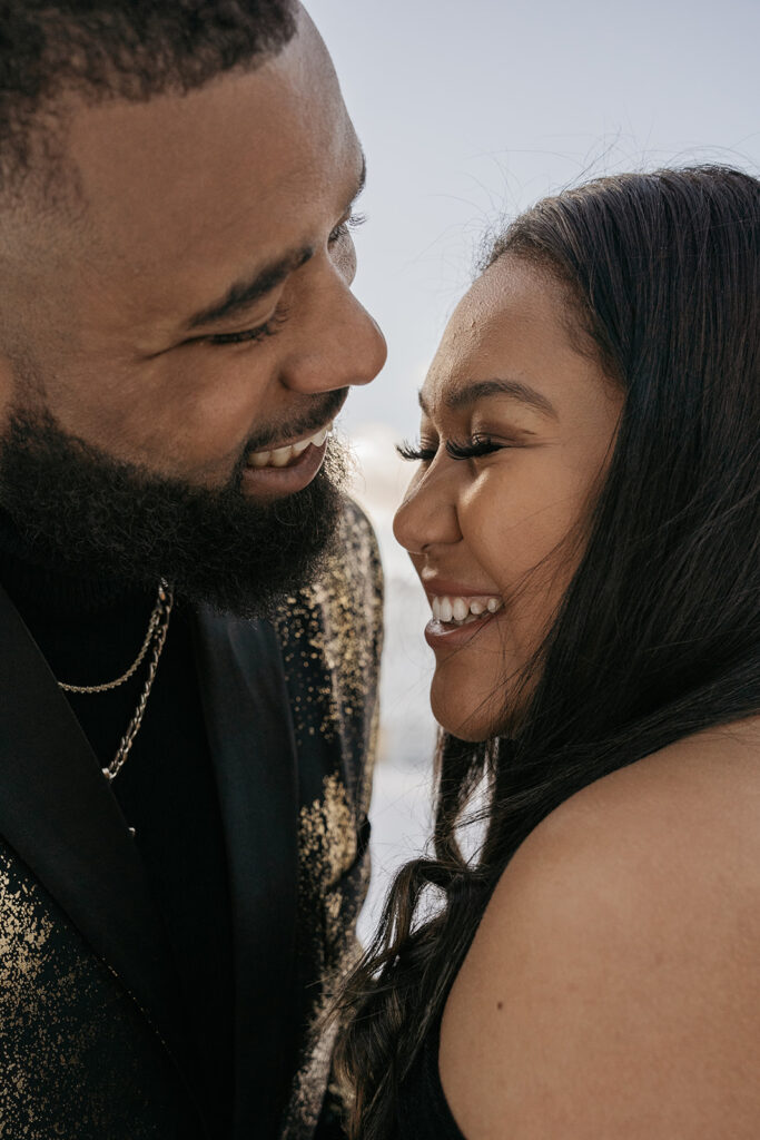 Smiling couple embracing outdoors.
