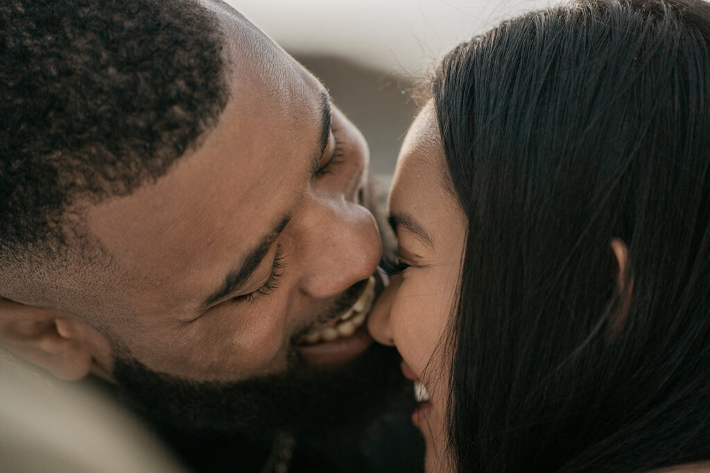 Close-up of a couple smiling intimately.