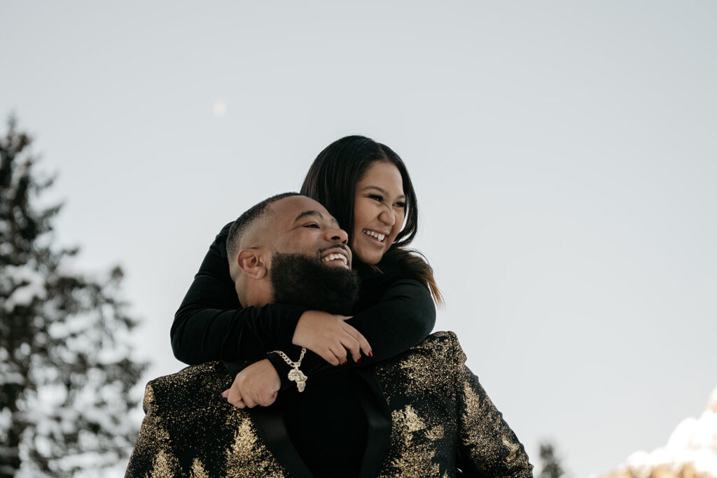 Smiling couple embracing outdoors in winter.