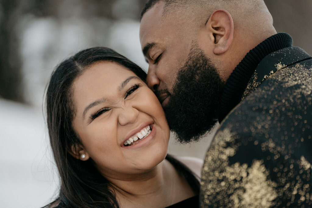 Smiling couple embracing outdoors.