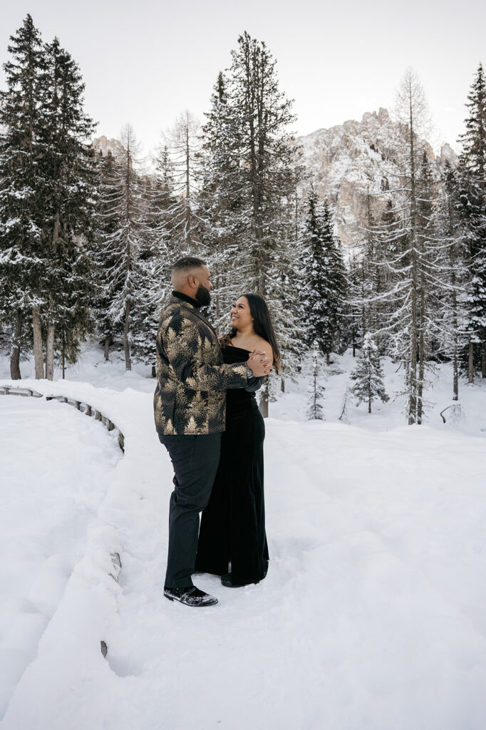 Couple embracing in snowy forest landscape