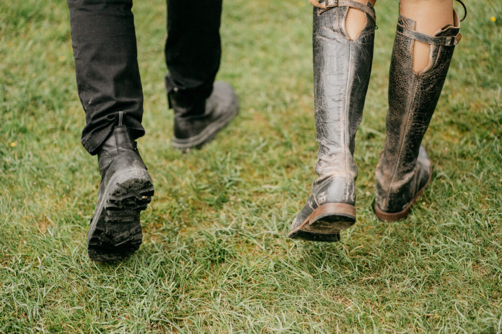 Pair walking on grass in boots