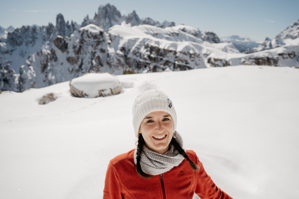 Smiling woman in snowy mountain landscape
