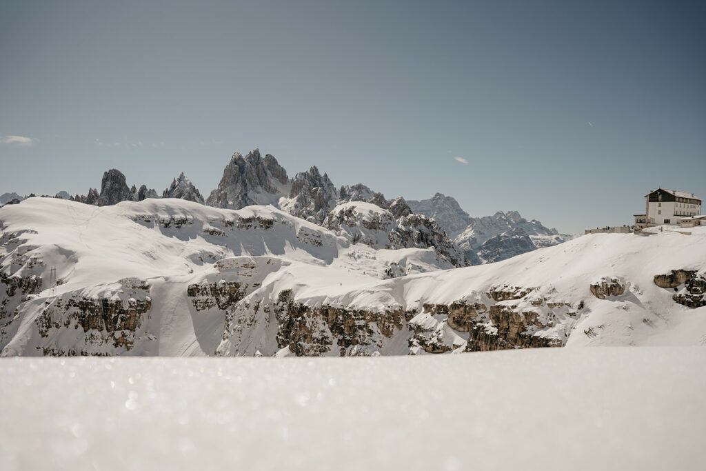 Snowy mountain landscape with blue sky.