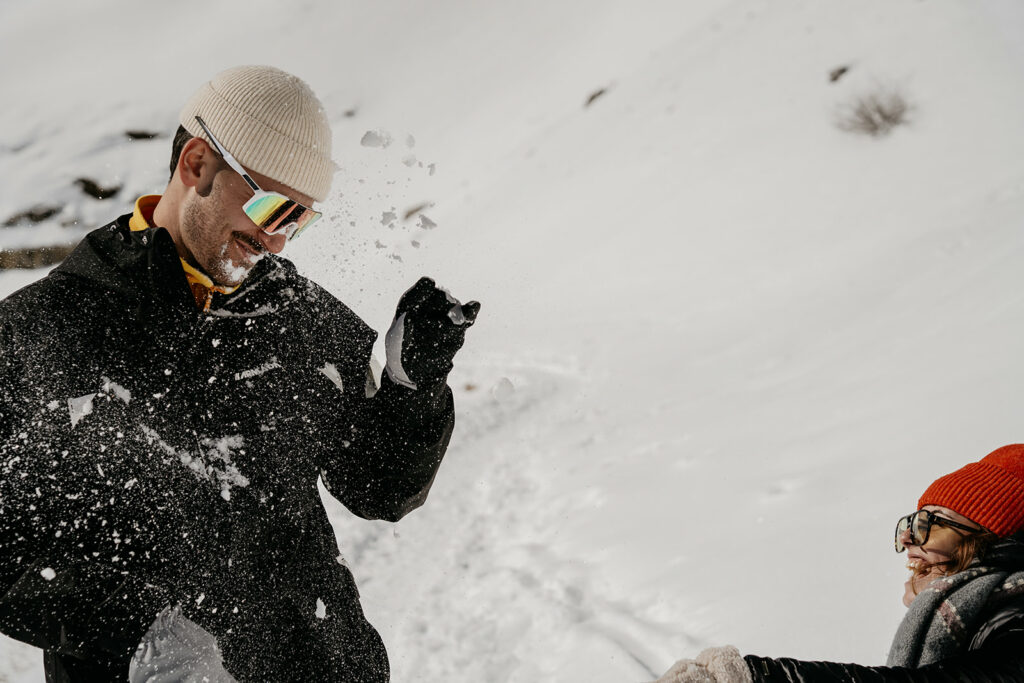 People having a snowball fight outdoors