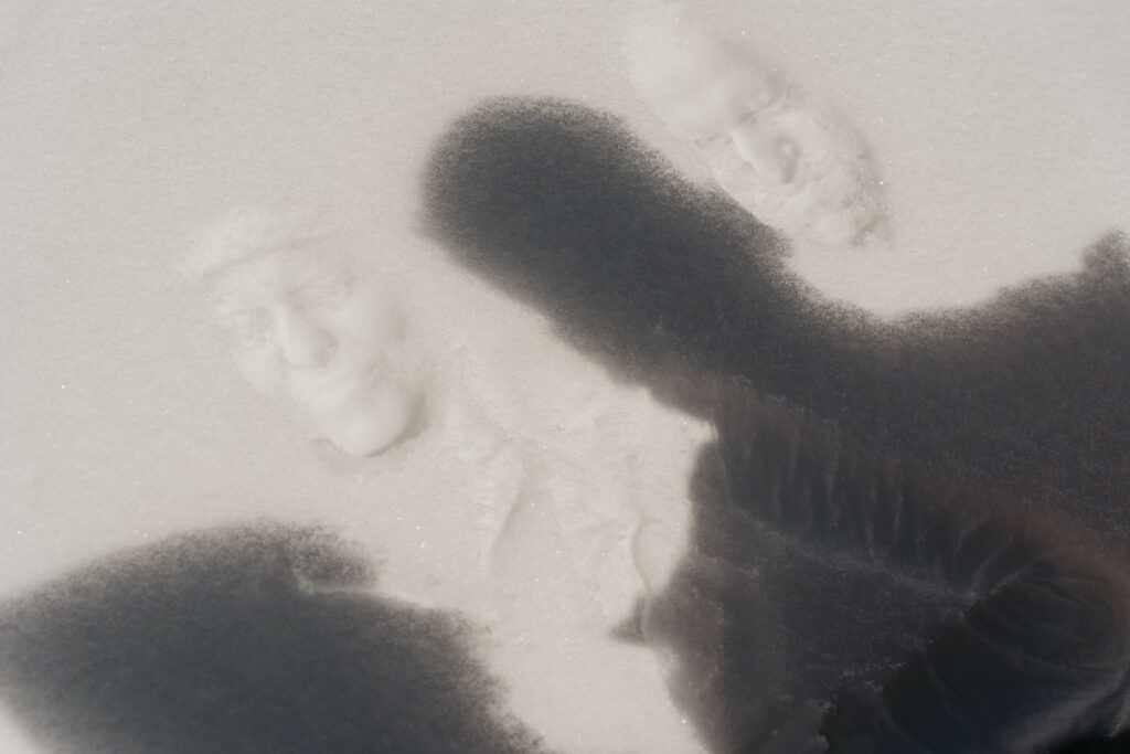Snow with imprinted human faces and shadow