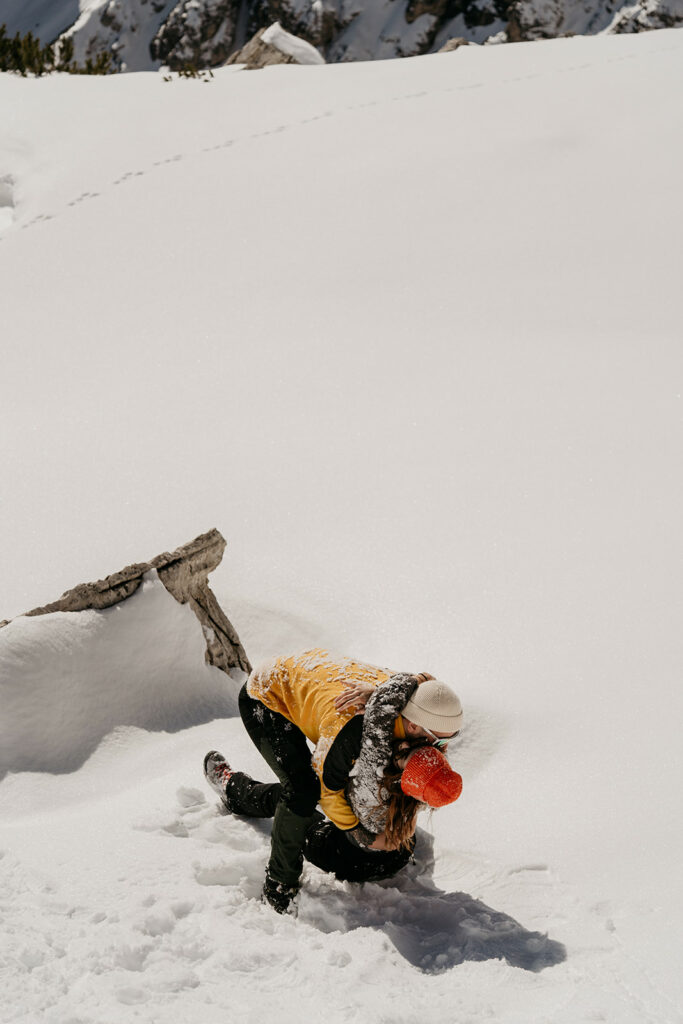 Couple playing in snow, sunny winter day