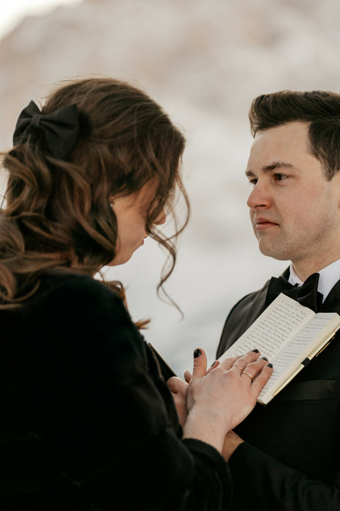 Couple sharing vows in formal attire.