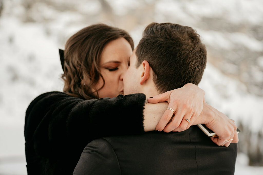 Couple kissing in snowy landscape