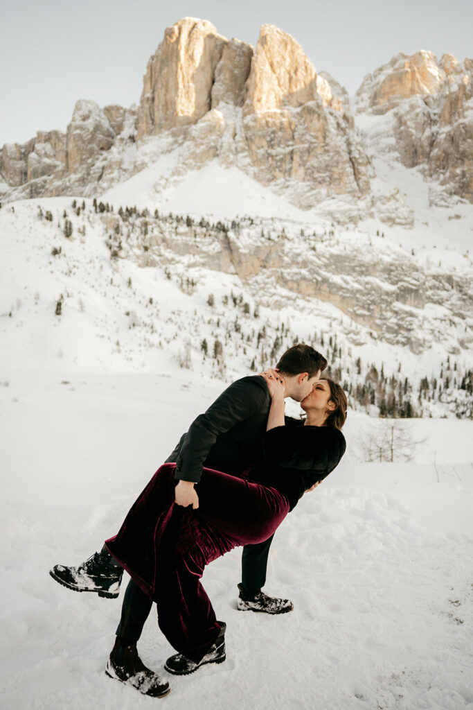 Couple kissing in snowy mountain landscape