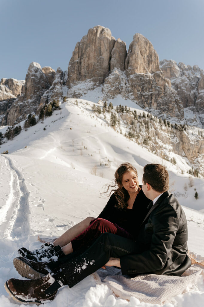 Couple enjoying snowy mountain view together.
