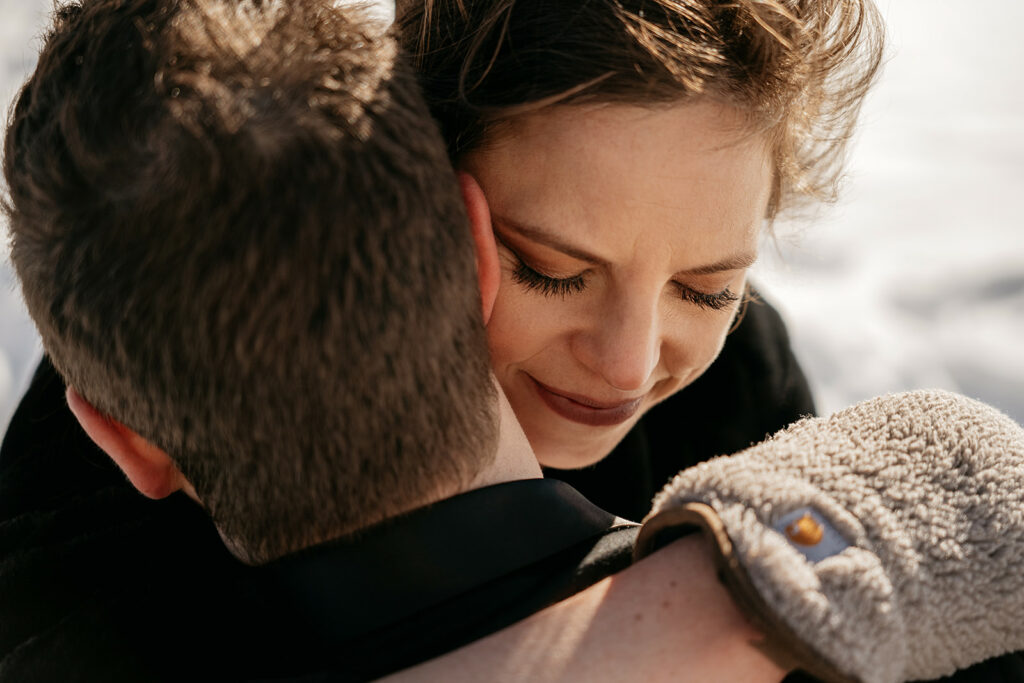 Emotional embrace between two people in winter.