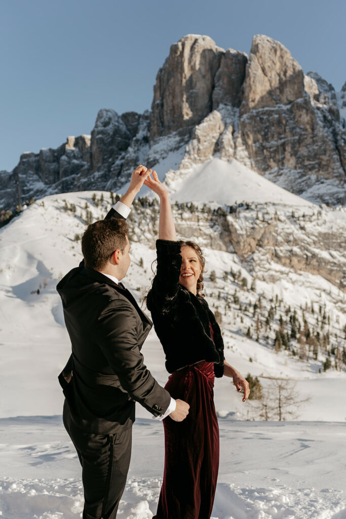 Couple dancing in snowy mountain landscape