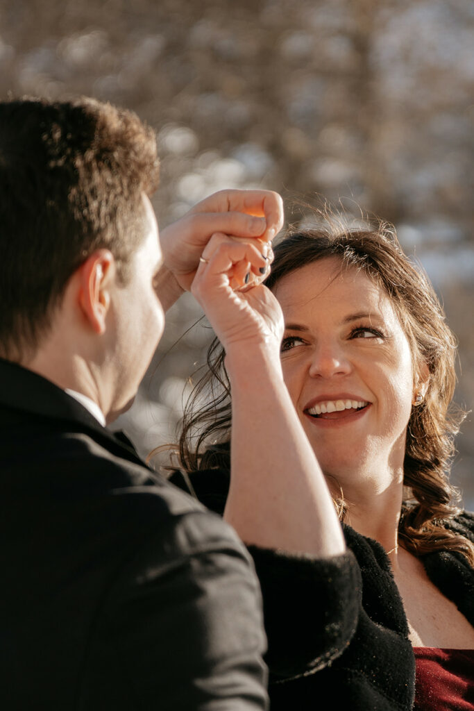Couple dancing and smiling outdoors.