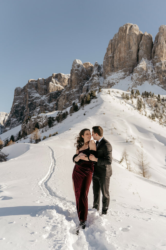Couple embracing in snowy mountain landscape