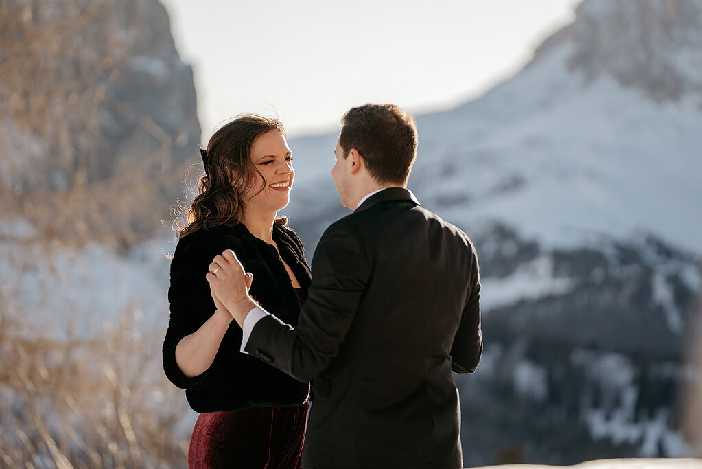 Couple dancing in snowy mountain landscape