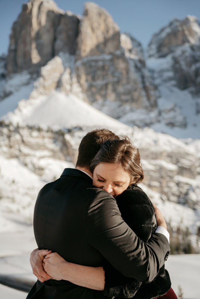 Couple embracing in snowy mountain landscape