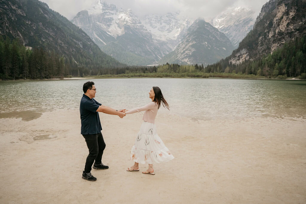 Couple dancing by a mountain lake.