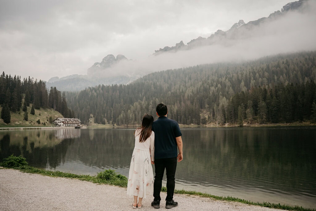 Couple enjoys scenic mountain lake view.