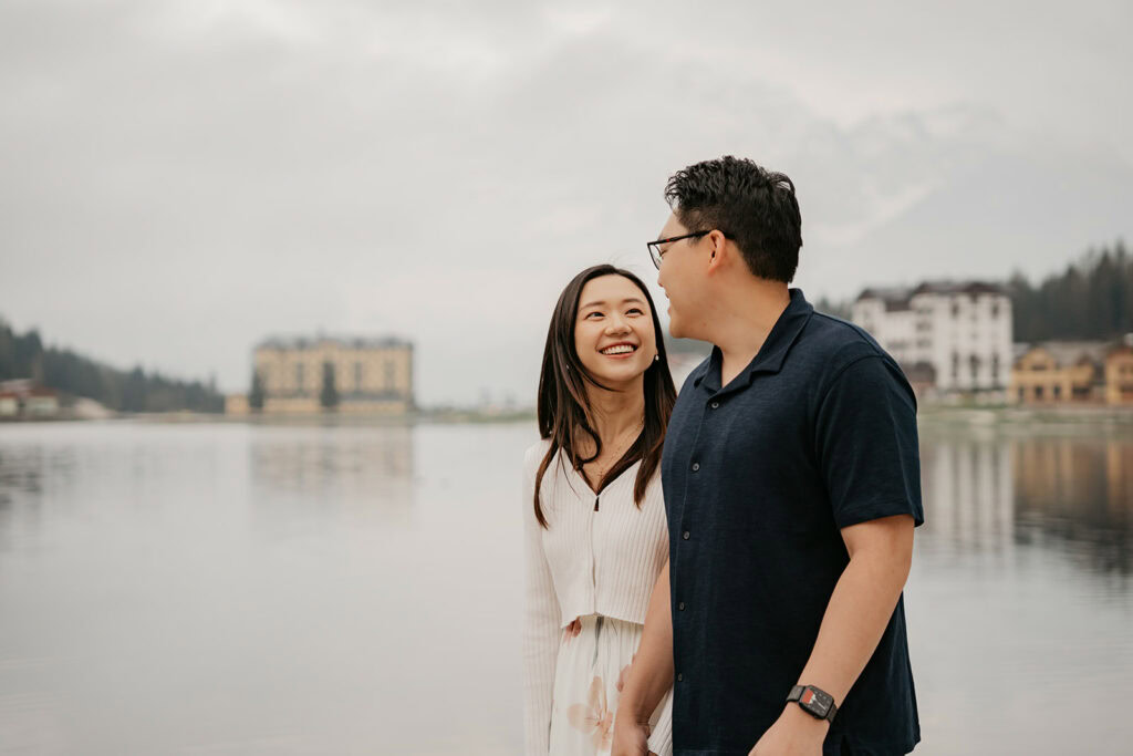 Couple smiling by a serene lakeside
