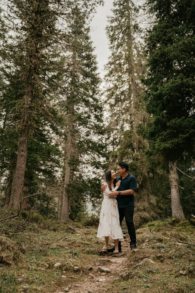 Couple embracing in a forest path