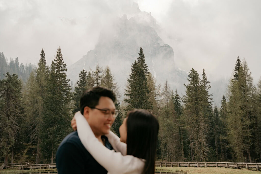 Couple embracing near misty mountain landscape