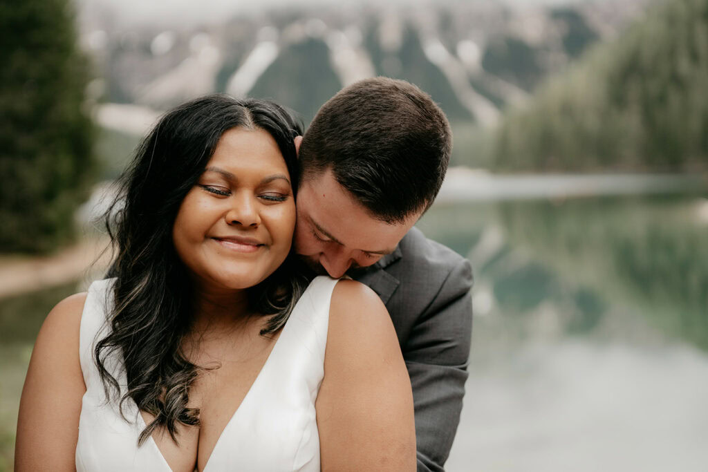 Couple embracing near scenic lake background