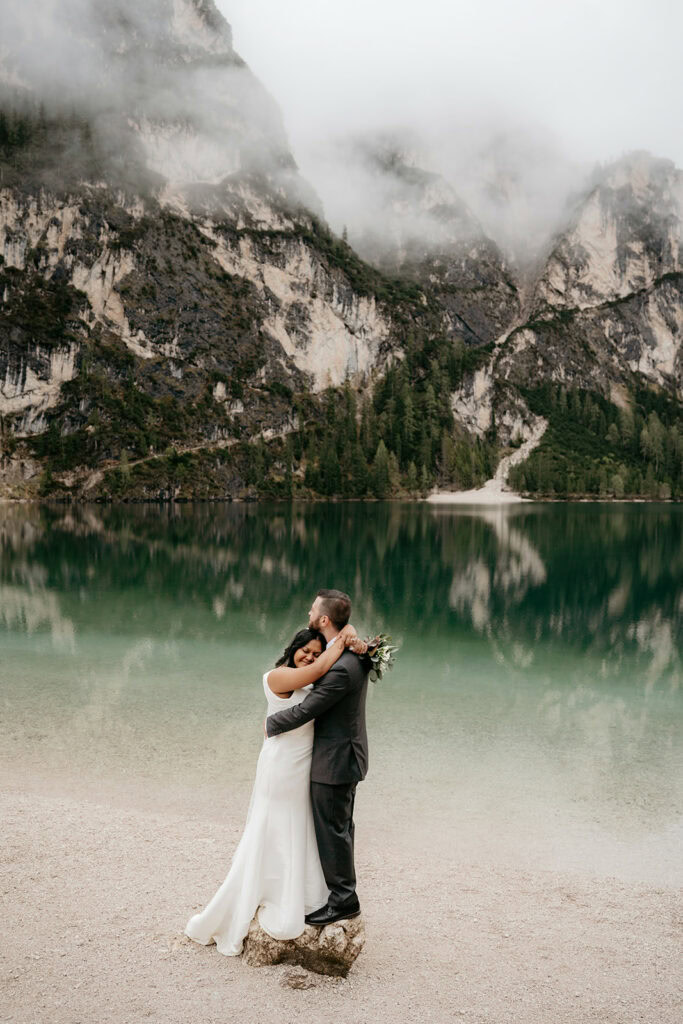Couple embraces by scenic mountain lake