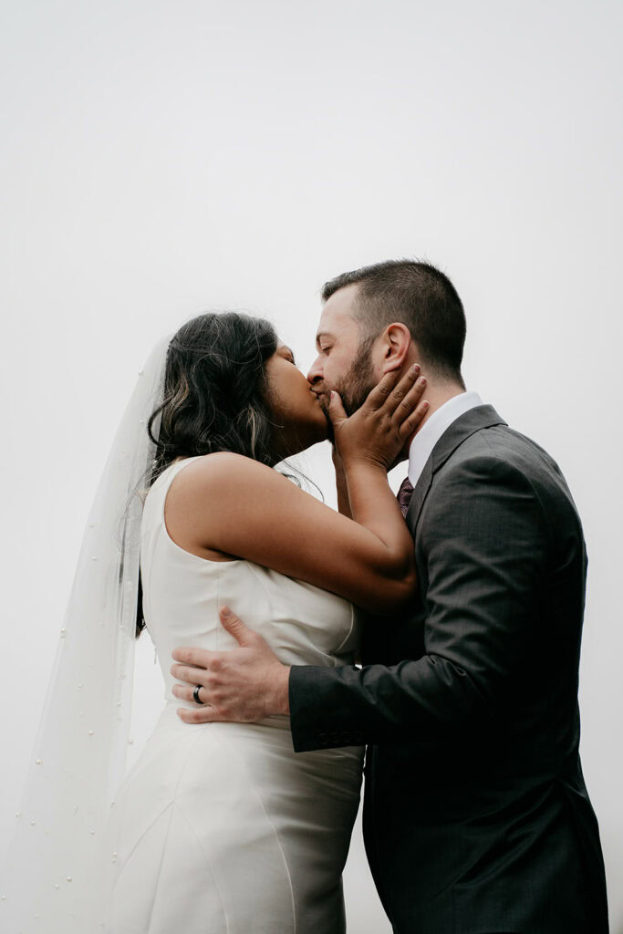 Bride and groom kissing on wedding day