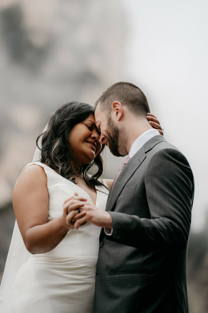Couple embracing on their wedding day outdoors.
