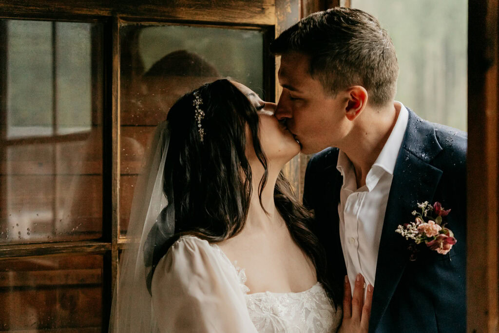 Bride and groom sharing a kiss.