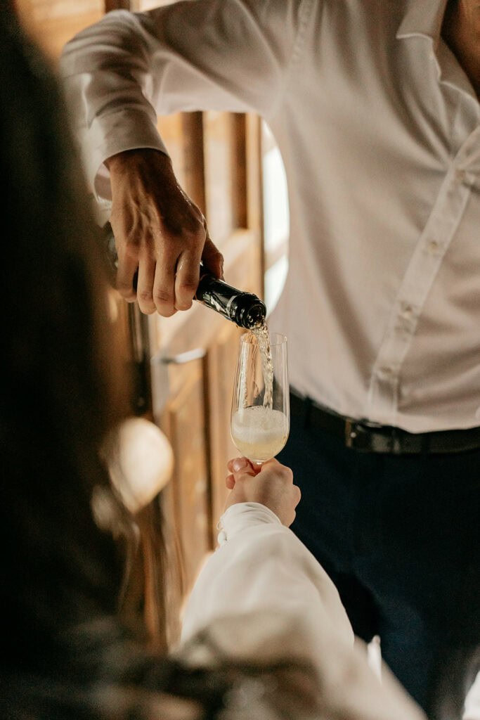 Pouring champagne into glass at celebration