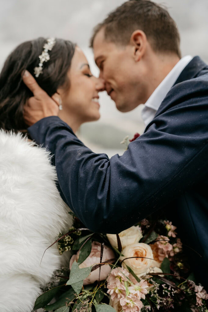 Couple embracing with flowers and fluffy shawl