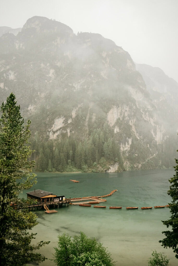 Misty mountain lake with wooden boat dock