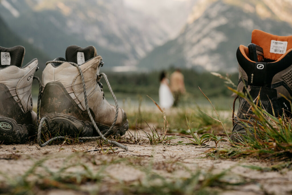 Worn hiking boots on a scenic mountain trail.