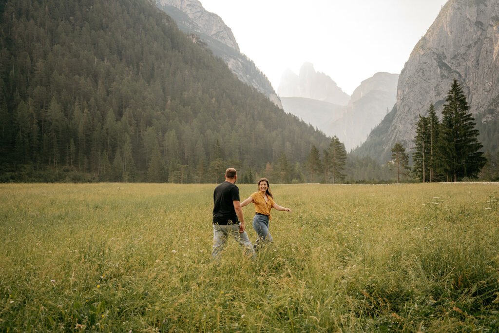 Couple walking in a picturesque mountain meadow.