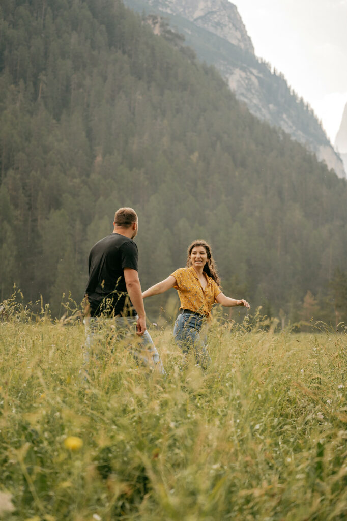 Couple walking happily in a scenic meadow