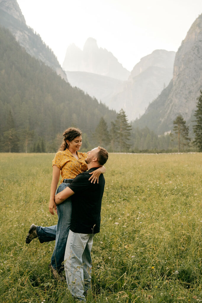 Couple embracing in mountain meadow