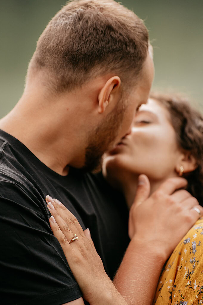 Close-up of couple kissing outdoors.
