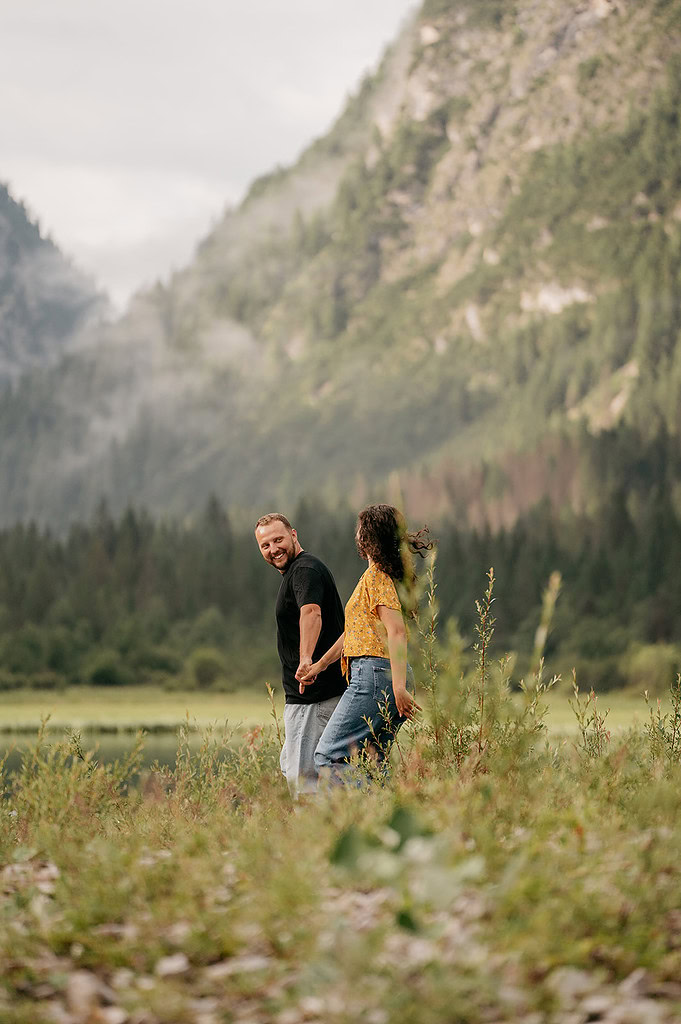 Couple holding hands in mountain landscape