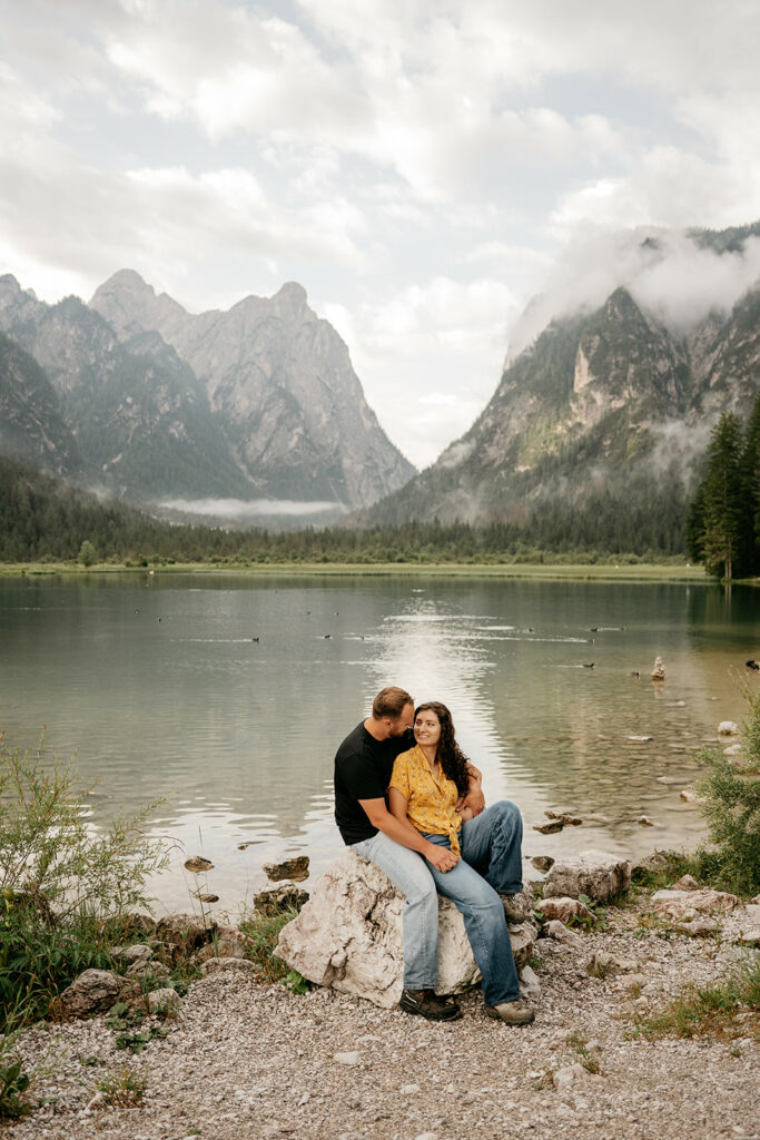Couple sitting by a mountain lake