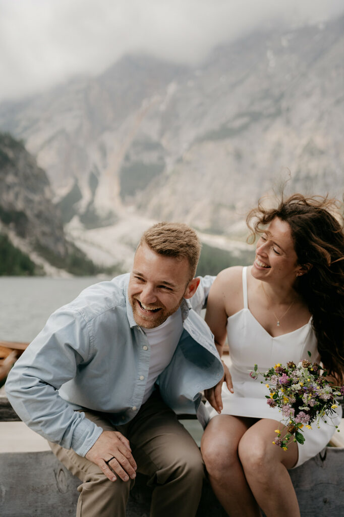 Couple smiling in mountain landscape with flowers