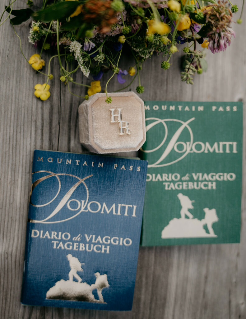 Two travel diaries with wildflowers and ring box.