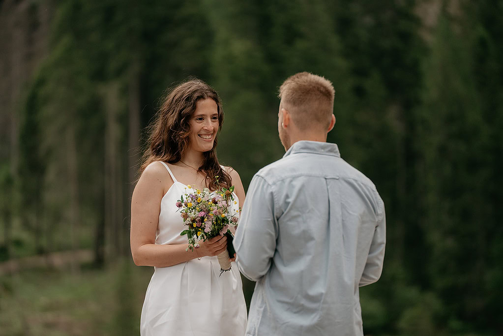 Couple exchanging vows in outdoor ceremony