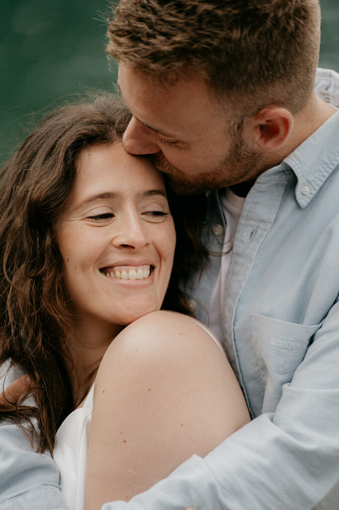 Smiling couple embracing outdoors.