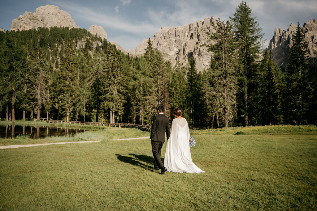 Couple walking in scenic mountain landscape.