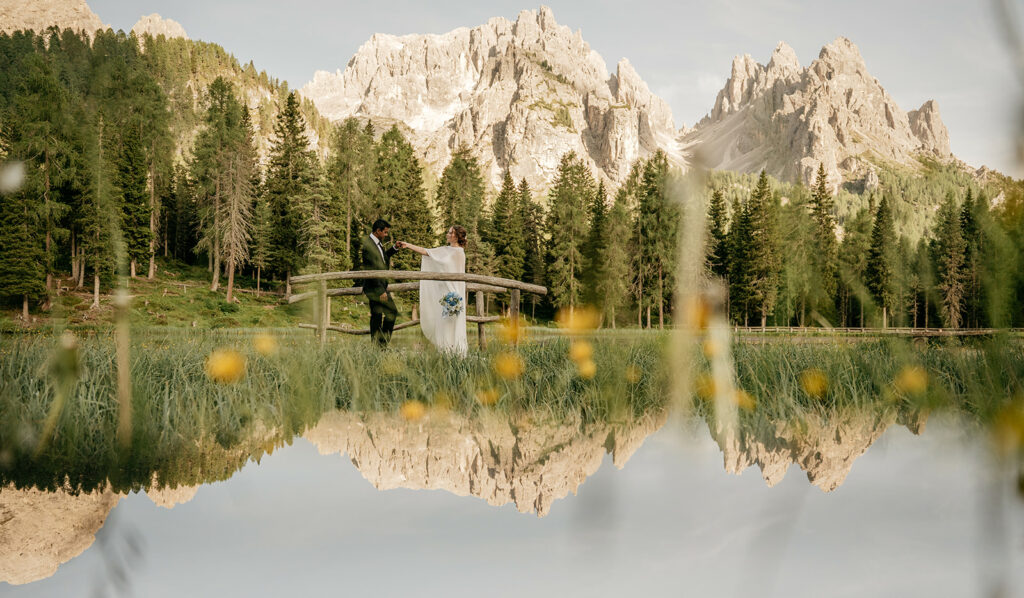 Couple on bridge with mountain reflection view