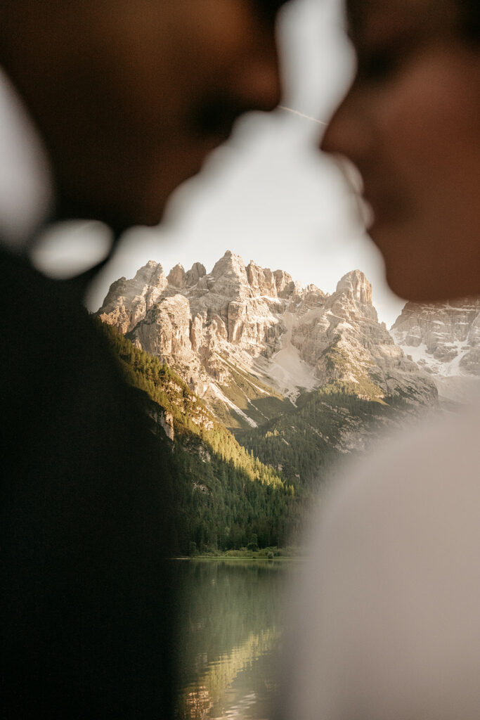Romantic couple silhouette with scenic mountain backdrop.