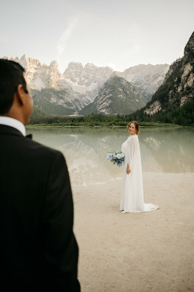 Bride and groom by mountain lake